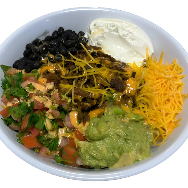 A Black Seed Halal Grill bowl with black beans, meat, shredded cheese, guacamole, and salsa.