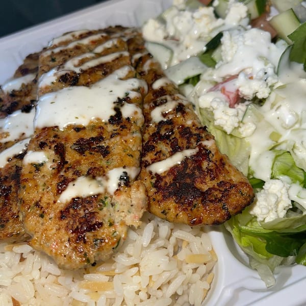 Black Seed Halal Grill's chicken kofta with white sauce, rice, and a side salad.