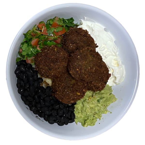 A Black Seed Halal Grill bowl with falafel, black beans, guacamole, sour cream, and salad.