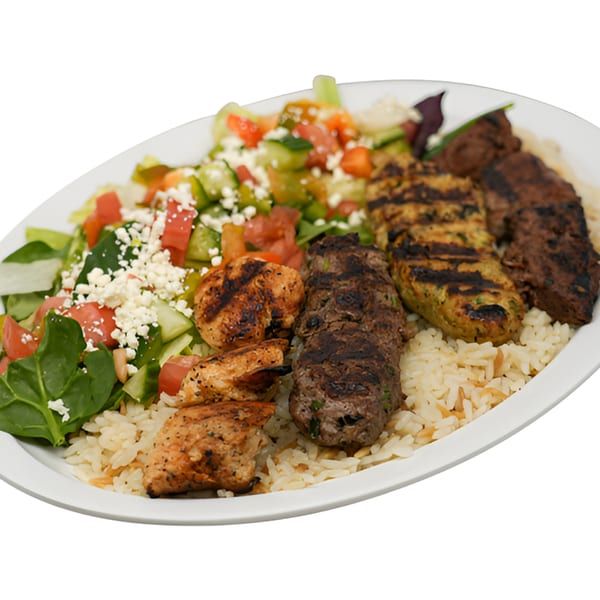 A Black Seed Halal Grill platter with grilled chicken, beef, rice, and a fresh salad.